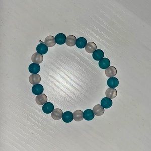This bracelet is from my business and it is a clear and white and blue bracelet.